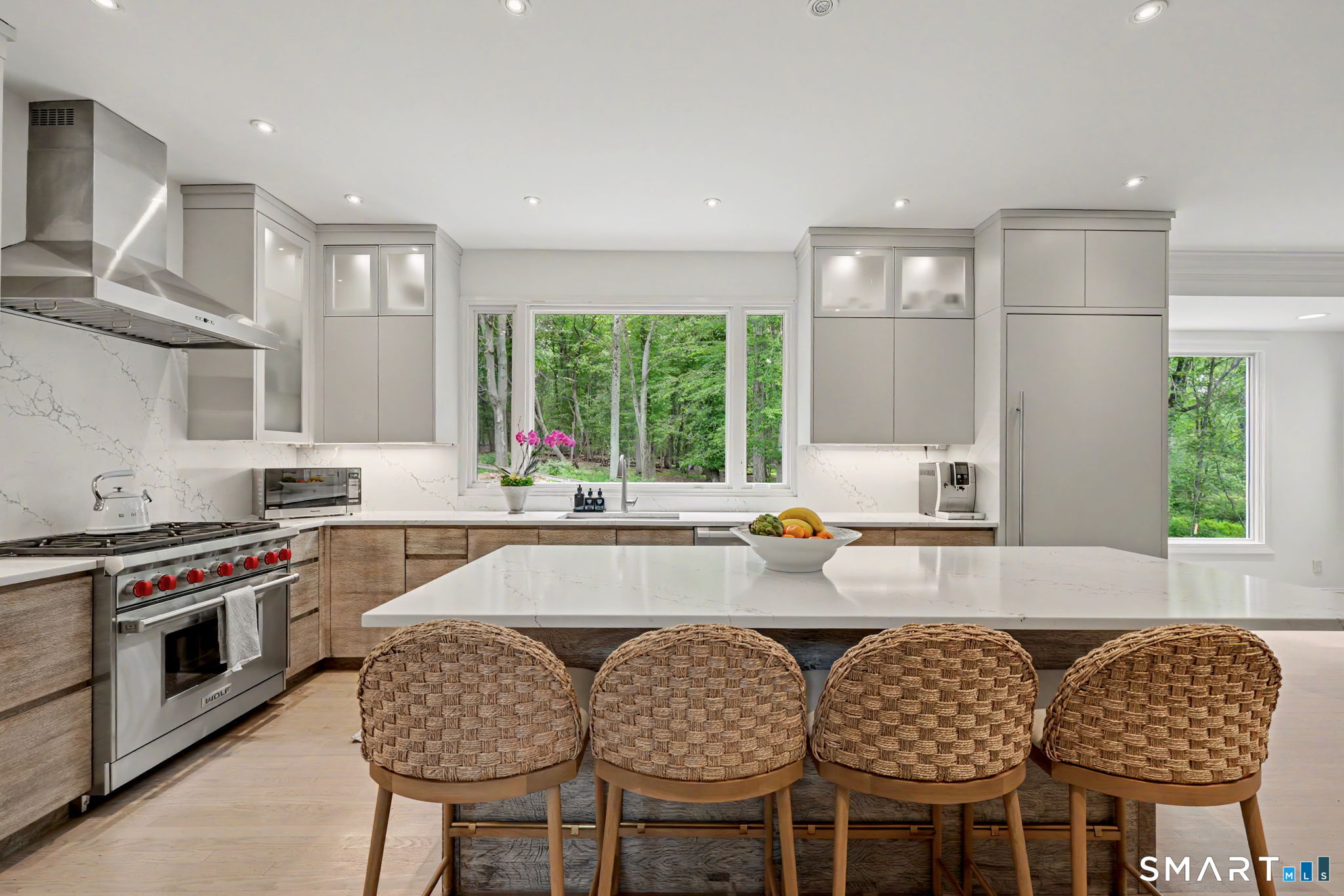 10 Side Hill Road Westport, CT 06880 - Photo 8 of 40 a kitchen with stainless steel appliances granite countertop a white table and chairs