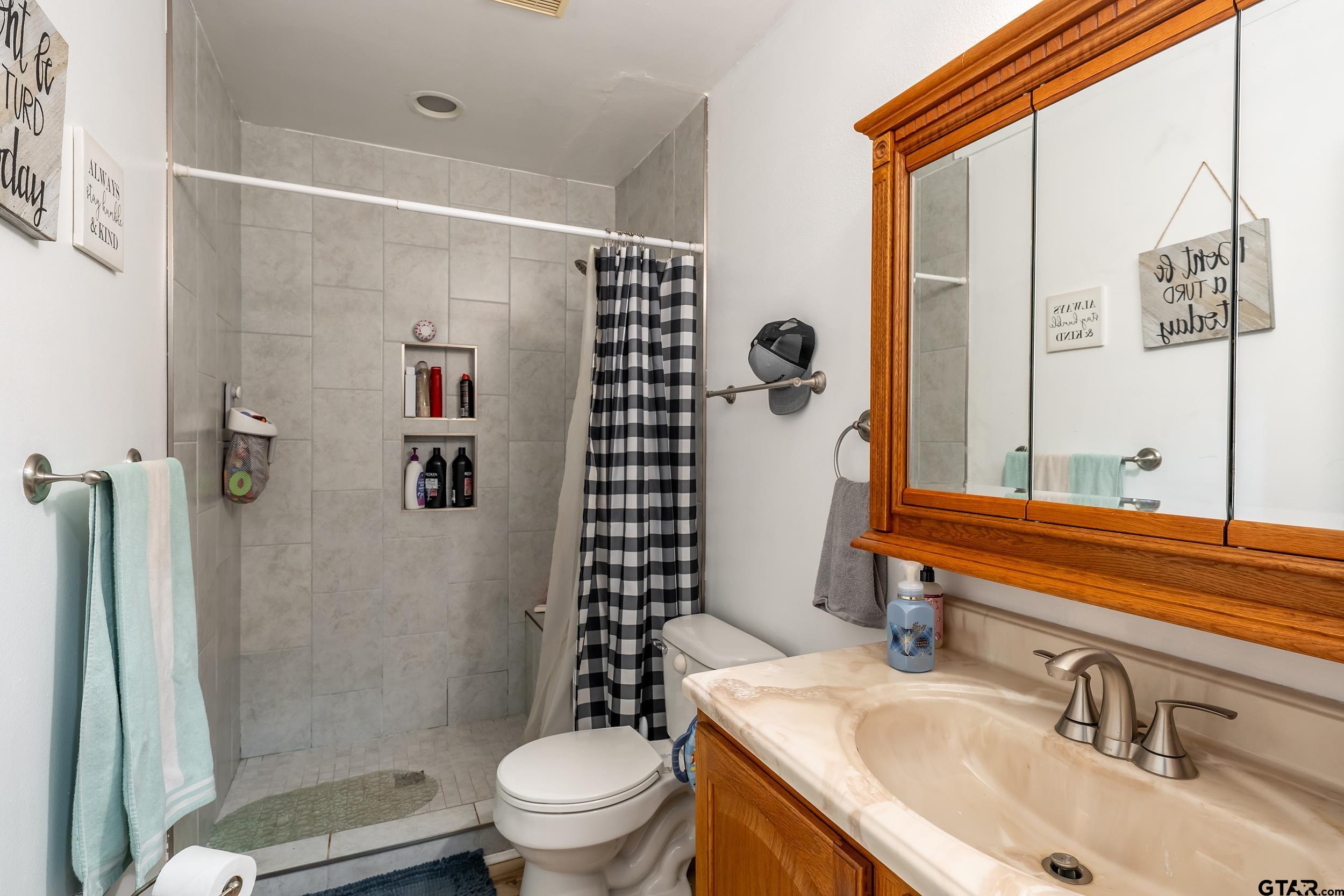 258 West 6th Street Rusk, TX 75785 - Photo 15 of 22 a bathroom with a sink toilet and shower