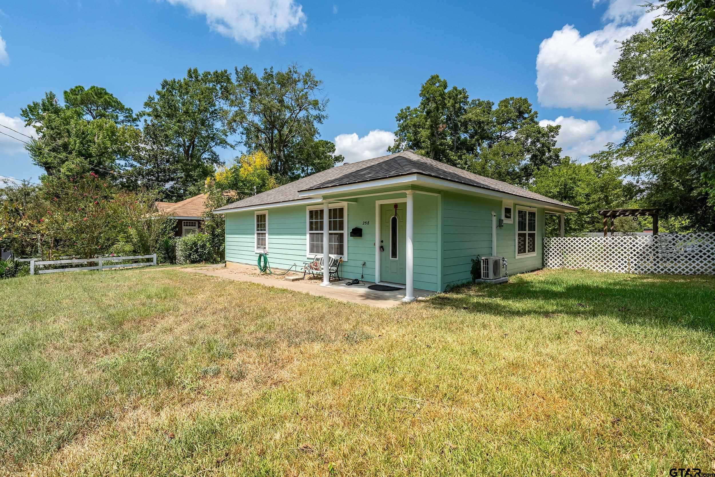 258 West 6th Street Rusk, TX 75785 - Photo 2 of 22 a yellow house with trees in front of it