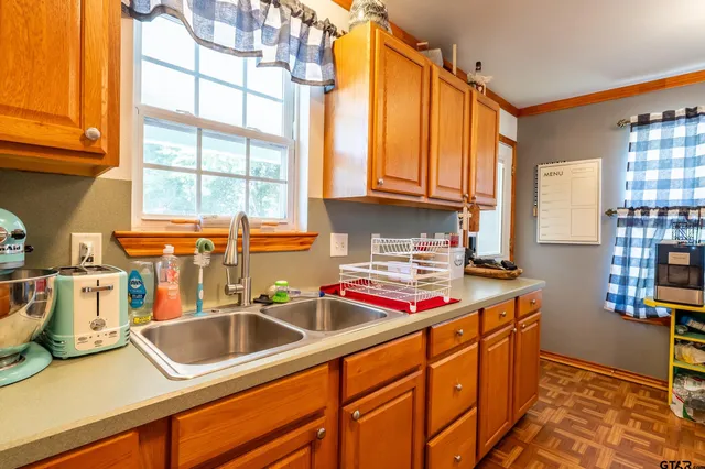 a kitchen with stainless steel appliances granite countertop a sink and a counter space