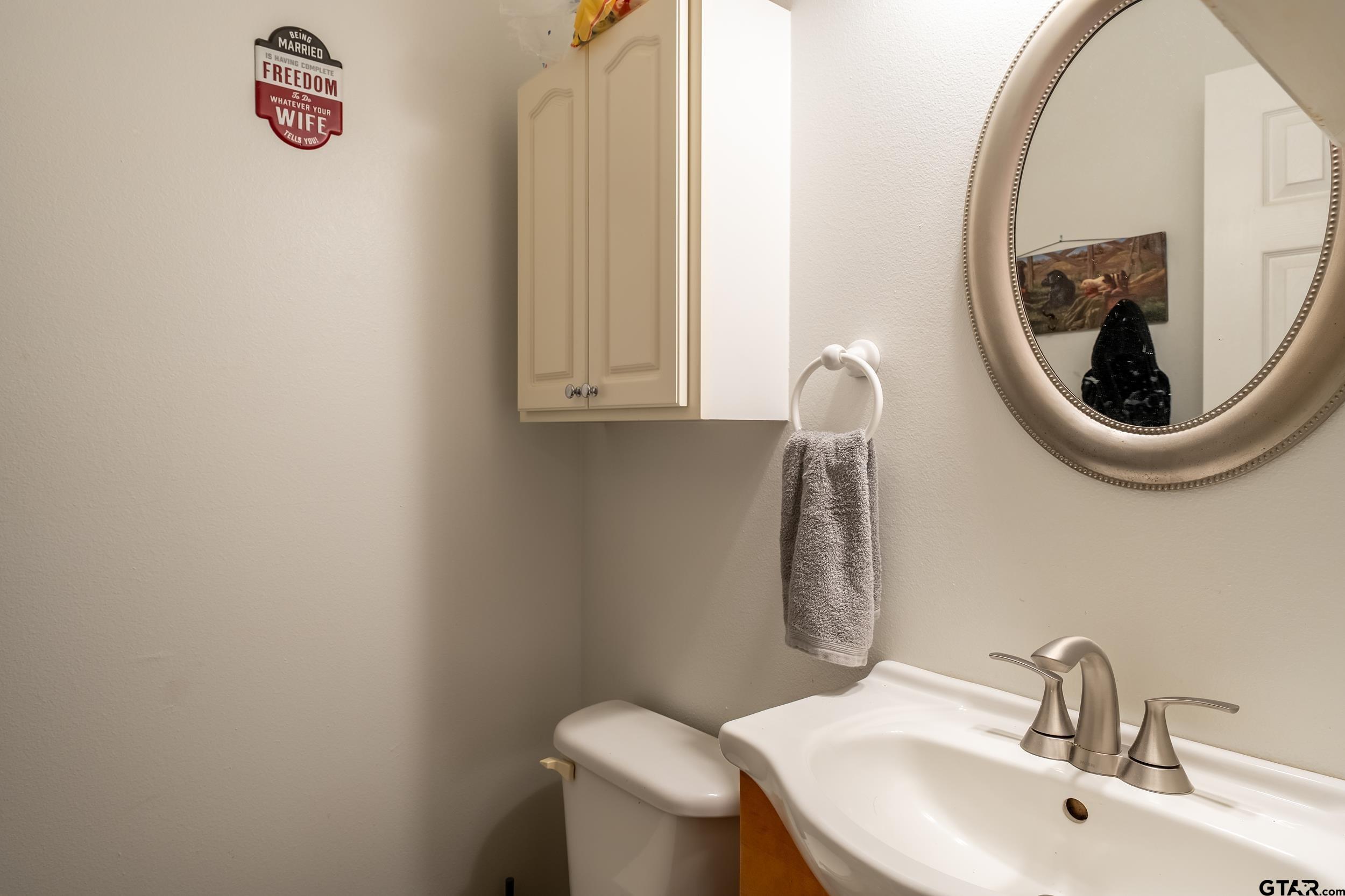 258 West 6th Street Rusk, TX 75785 - Photo 10 of 22 a bathroom with a sink and a mirror