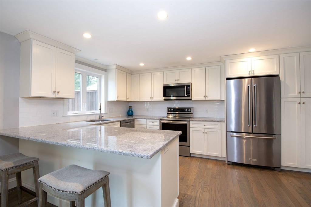 474 King Street, Unit 474 Cohasset, MA 02025 - Photo 3 of 18 a kitchen with a refrigerator a microwave a sink and a stove