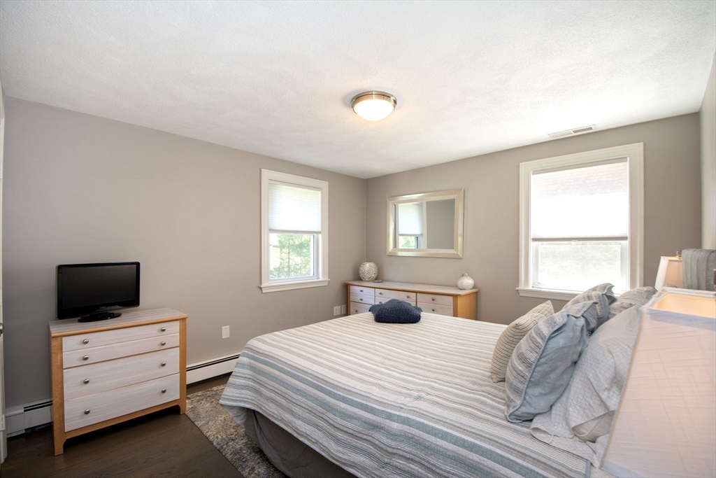 474 King Street, Unit 474 Cohasset, MA 02025 - Photo 8 of 18 a bedroom with a bed and a window