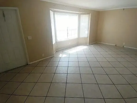 a view of an empty room and window