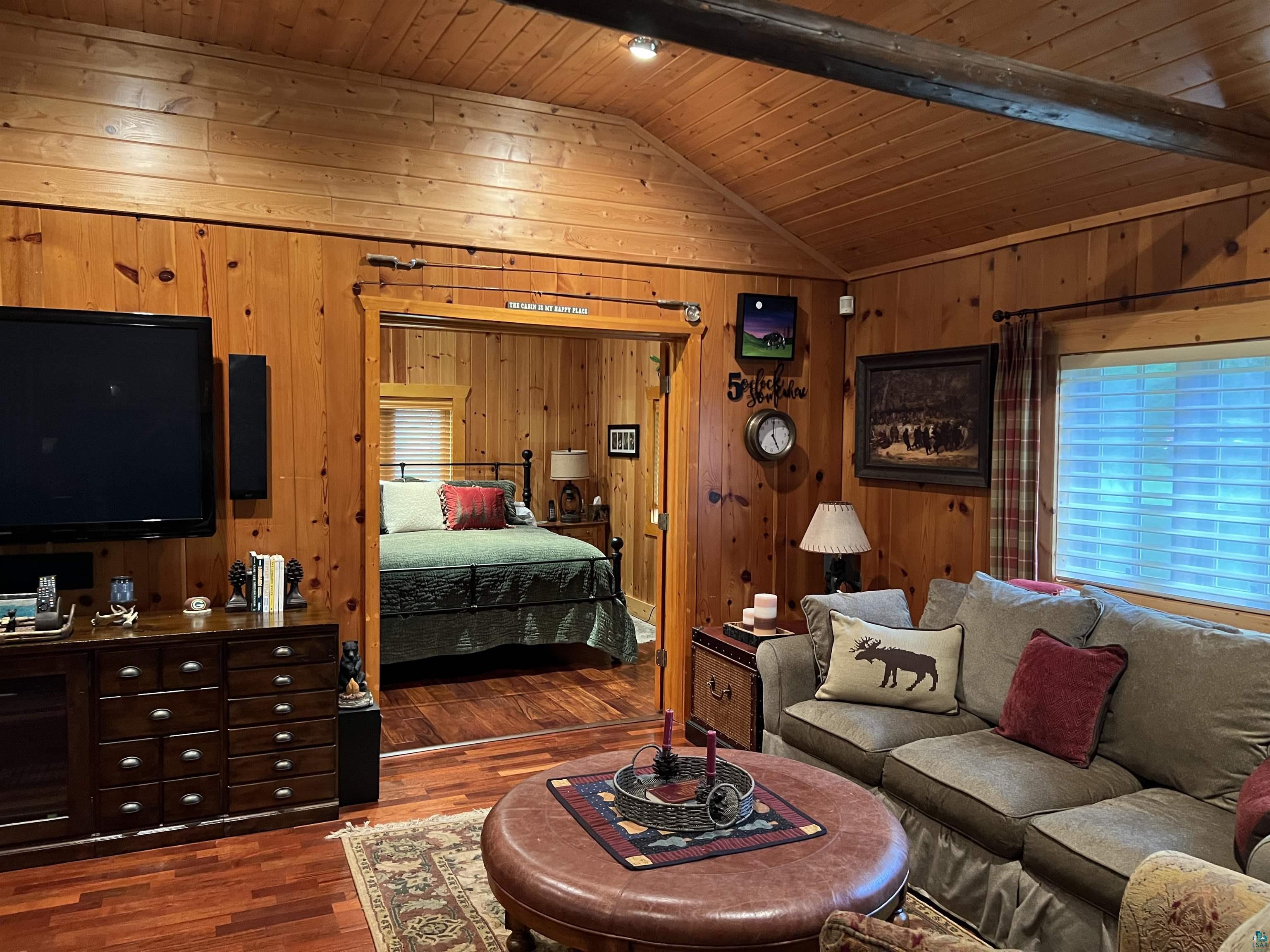 46835 Behan Drive Cable, WI 54821 - Photo 12 of 42 Bedroom with wood walls, lofted ceiling with beams, dark hardwood / wood-style flooring, and wood ceiling