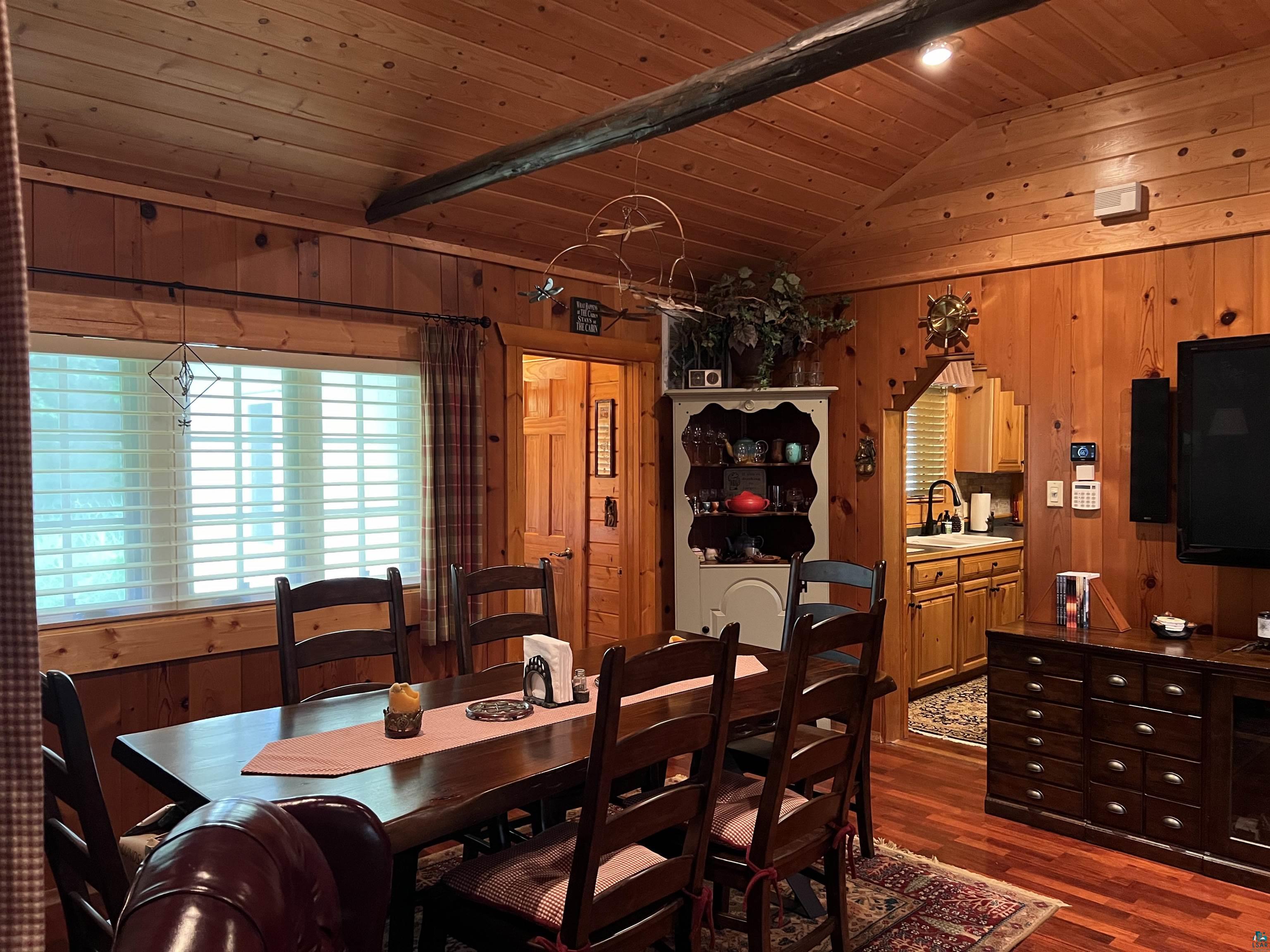 46835 Behan Drive Cable, WI 54821 - Photo 13 of 42 Dining area featuring hardwood / wood-style floors, lofted ceiling, wooden ceiling, wood walls, and sink