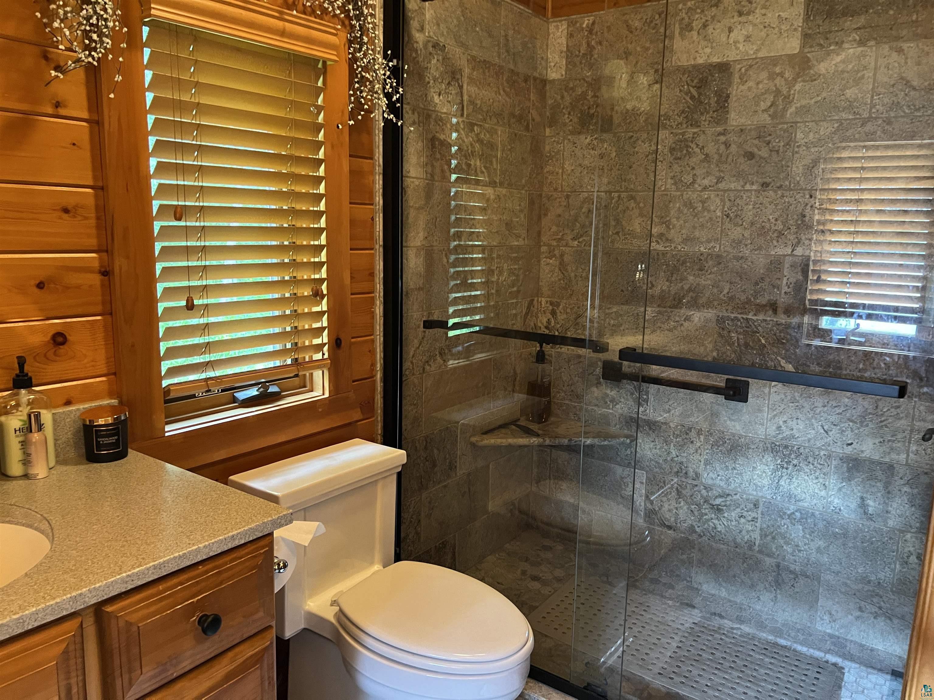 46835 Behan Drive Cable, WI 54821 - Photo 14 of 42 Bathroom featuring vanity, a shower with door, and toilet