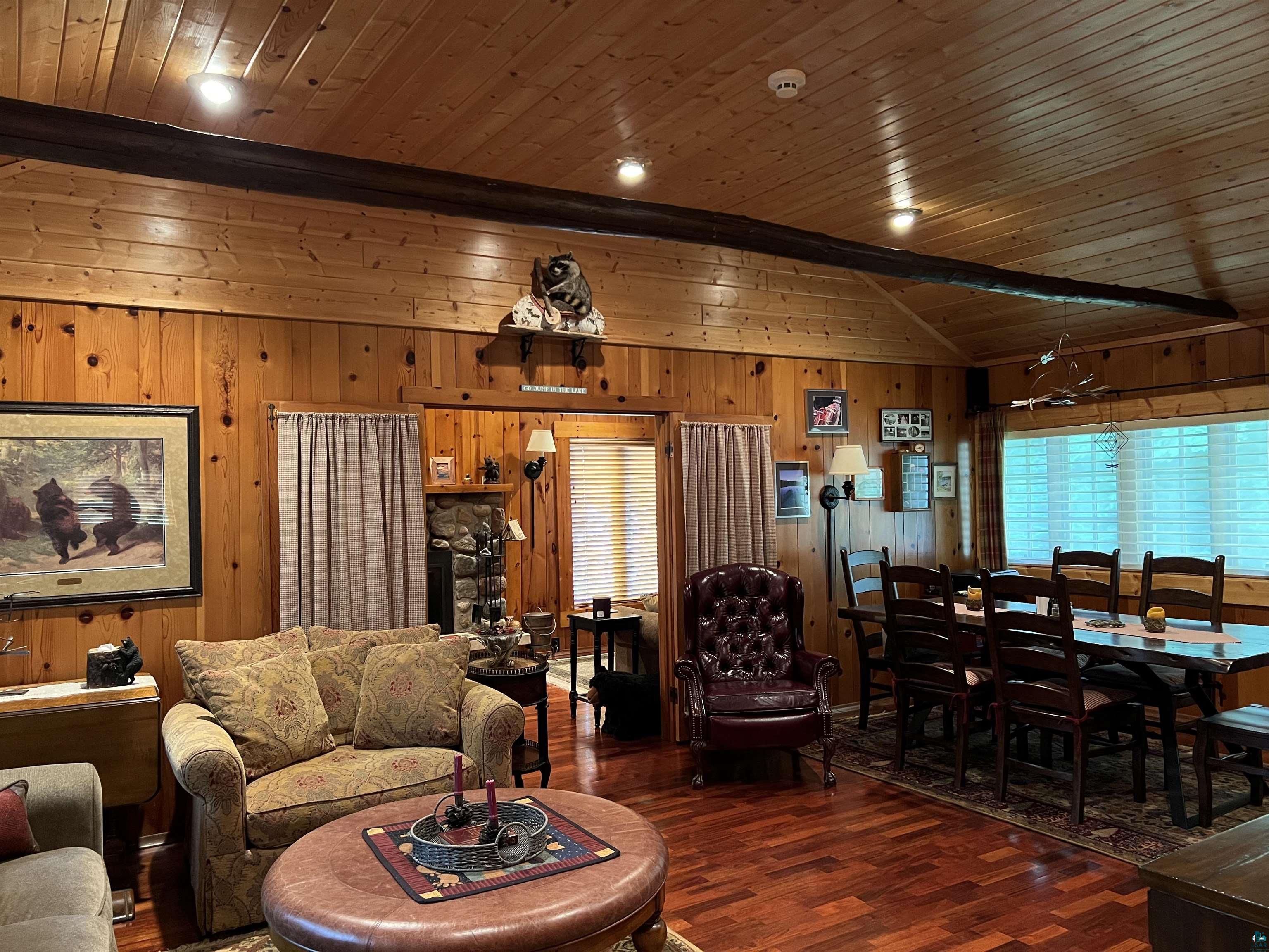 46835 Behan Drive Cable, WI 54821 - Photo 20 of 42 Living room featuring dark wood-type flooring, vaulted ceiling, wood walls, and wooden ceiling