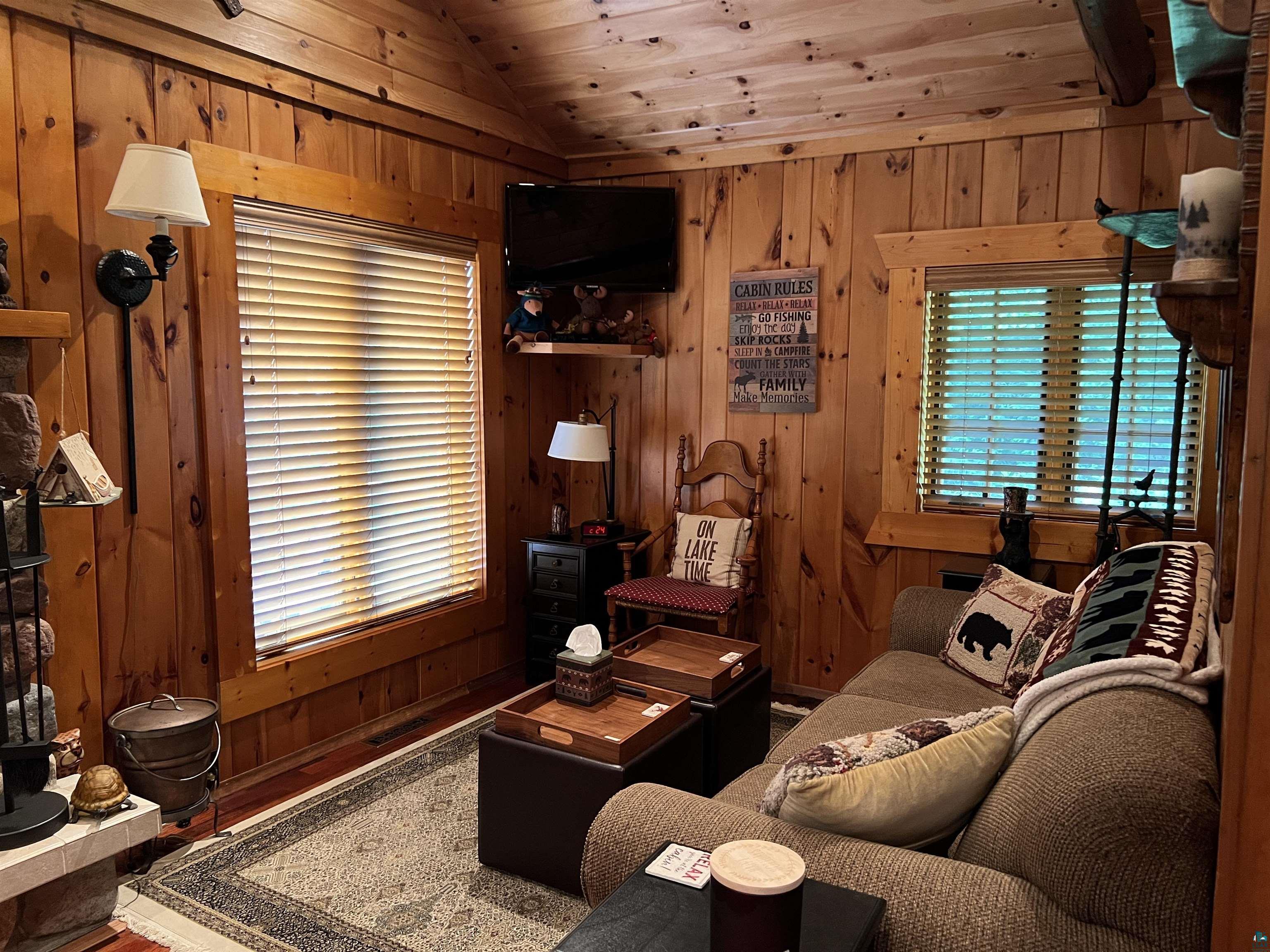 46835 Behan Drive Cable, WI 54821 - Photo 22 of 42 Living room with lofted ceiling, wood walls, and wood ceiling