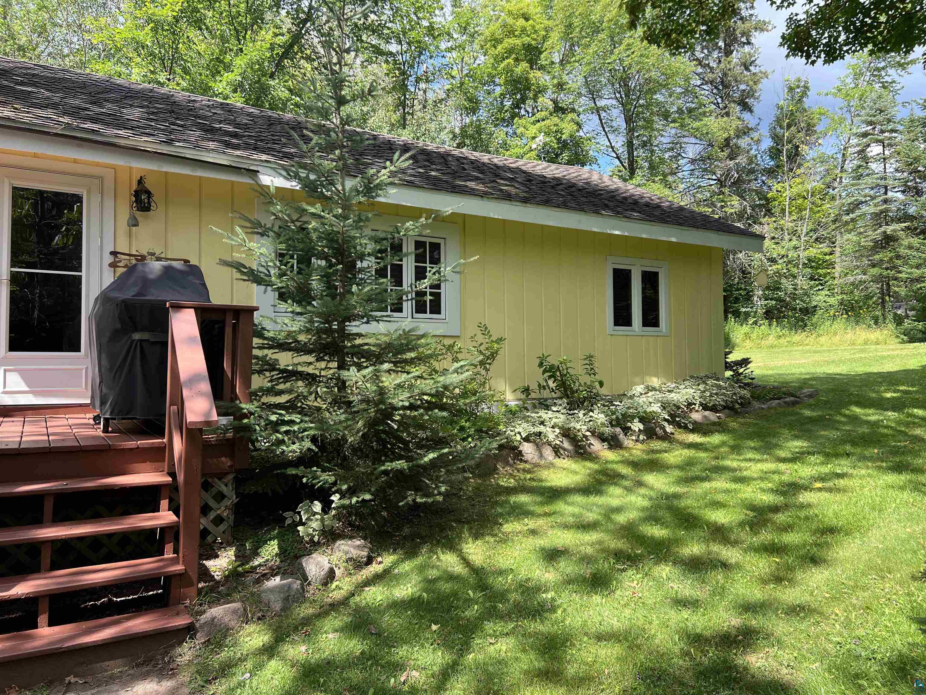46835 Behan Drive Cable, WI 54821 - Photo 38 of 42 View of home's exterior featuring a wooden deck and a lawn