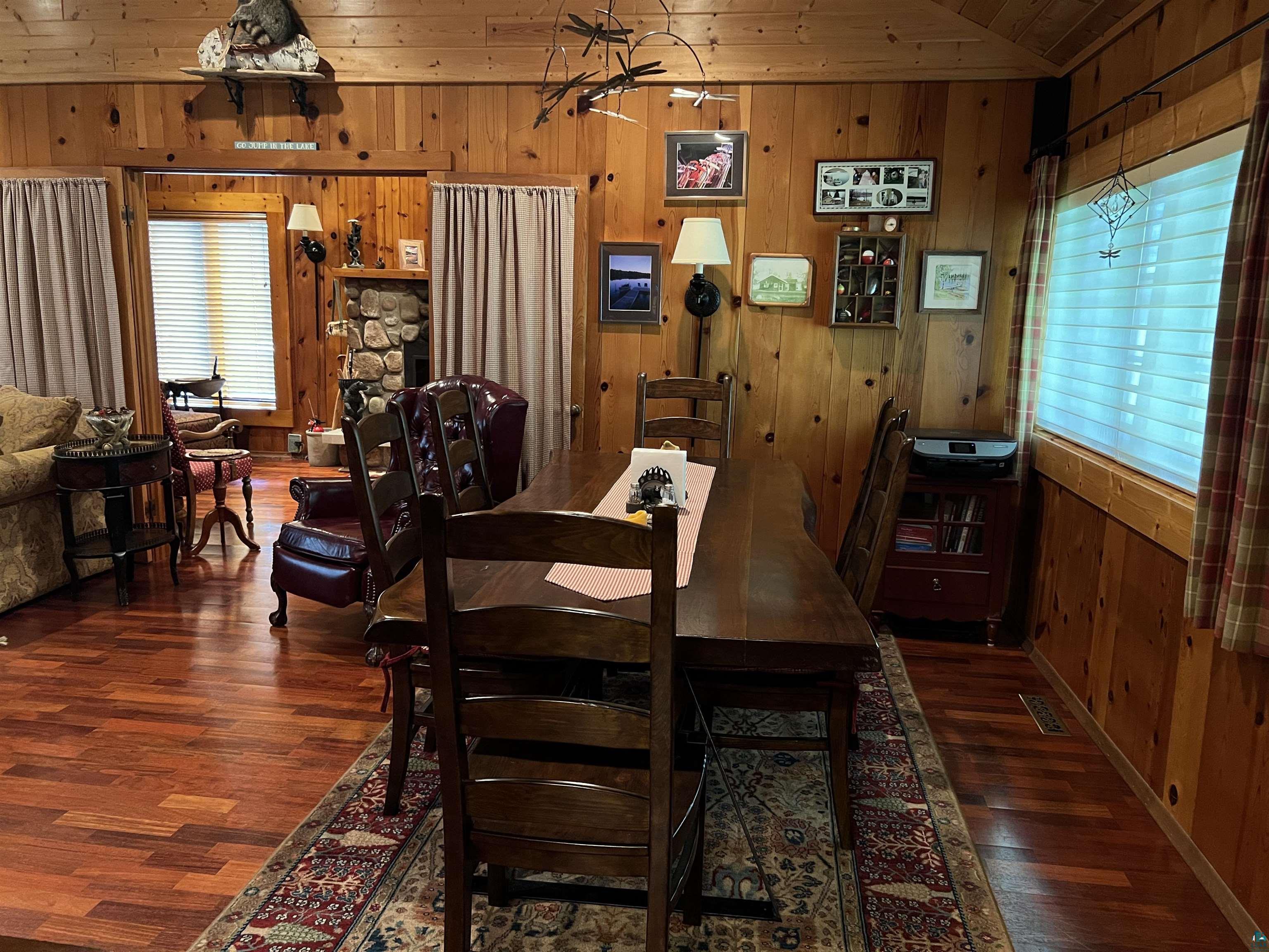 46835 Behan Drive Cable, WI 54821 - Photo 10 of 42 Dining area featuring lofted ceiling, dark hardwood / wood-style flooring, wooden walls, and wood ceiling