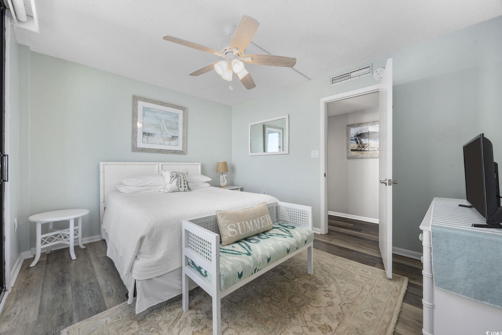 10100 Beach Club Drive, Unit 14F Myrtle Beach, SC 29572 - Photo 24 of 40 Bedroom featuring wood finished floors and a ceiling fan