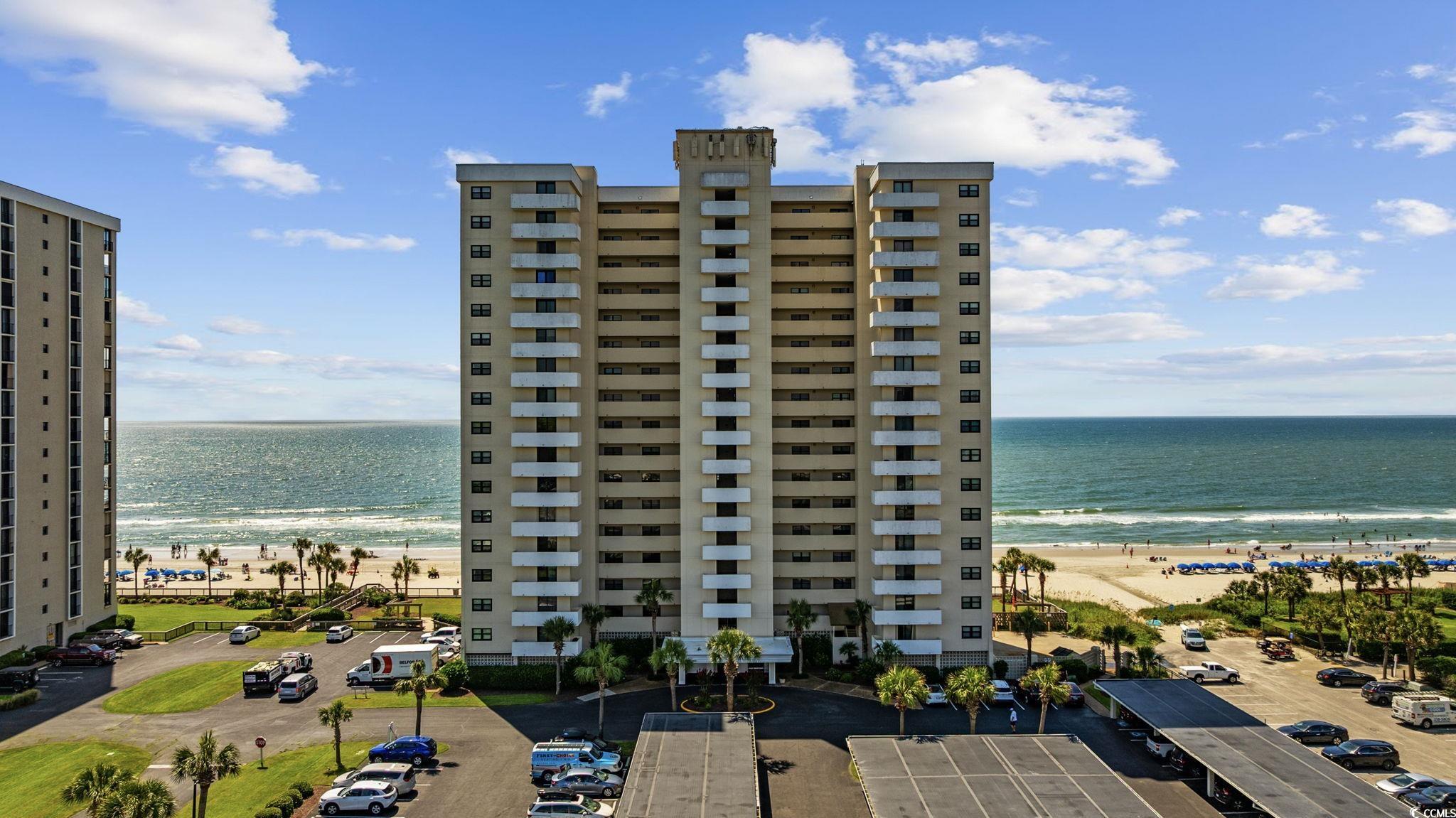 10100 Beach Club Drive, Unit 14F Myrtle Beach, SC 29572 - Photo 3 of 40 View of apartment building / complex with view of water and beach