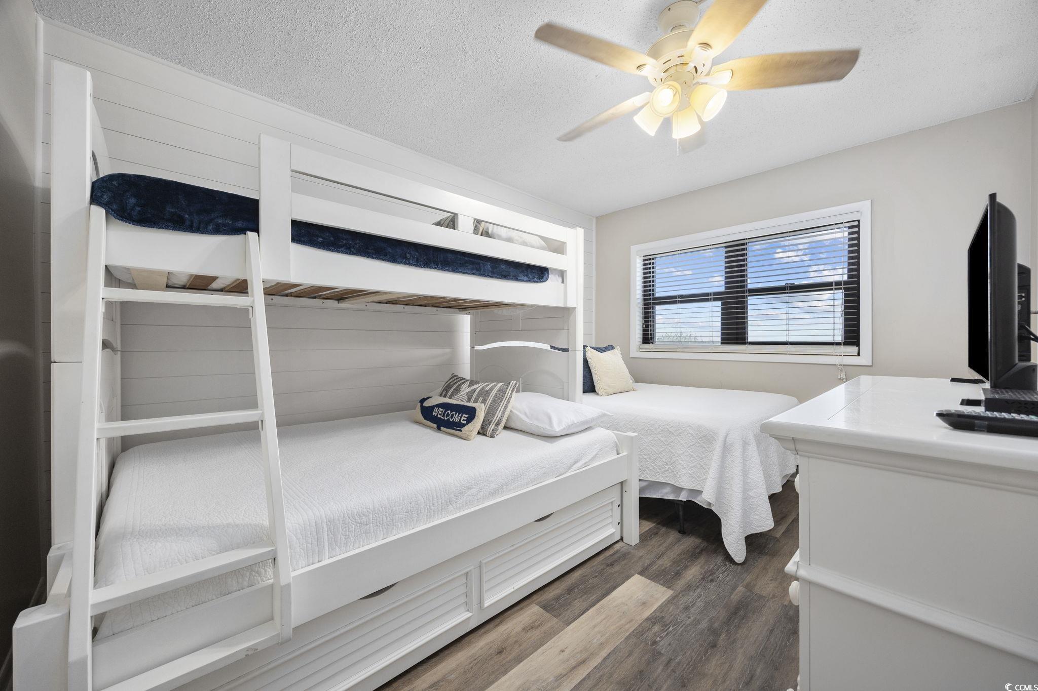 10100 Beach Club Drive, Unit 14F Myrtle Beach, SC 29572 - Photo 29 of 40 Bedroom featuring dark wood finished floors, a textured ceiling, and ceiling fan