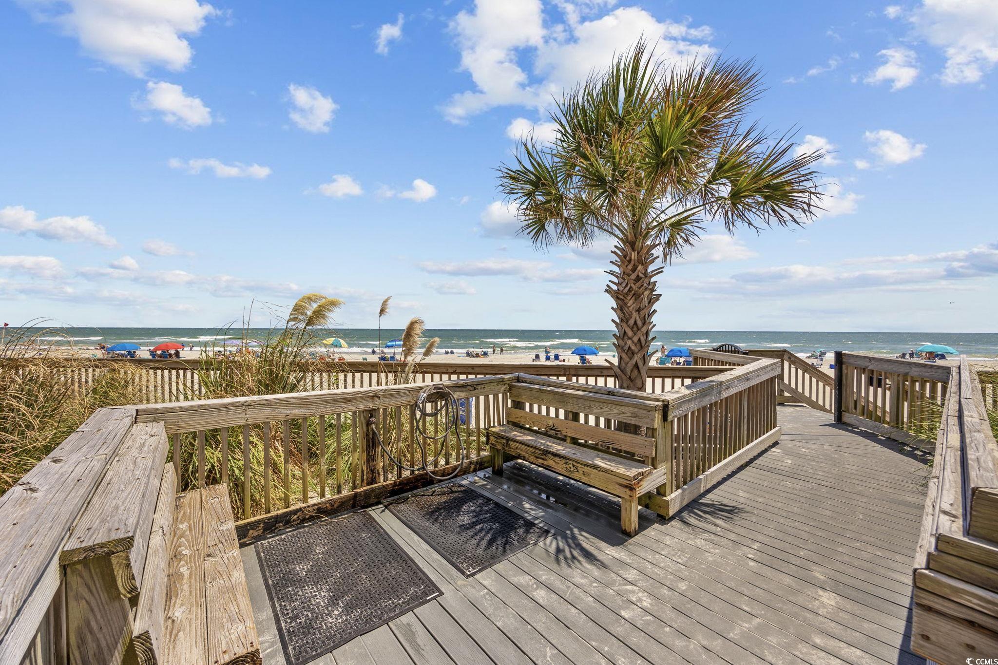 10100 Beach Club Drive, Unit 14F Myrtle Beach, SC 29572 - Photo 31 of 40 Wooden deck featuring view of water and beach
