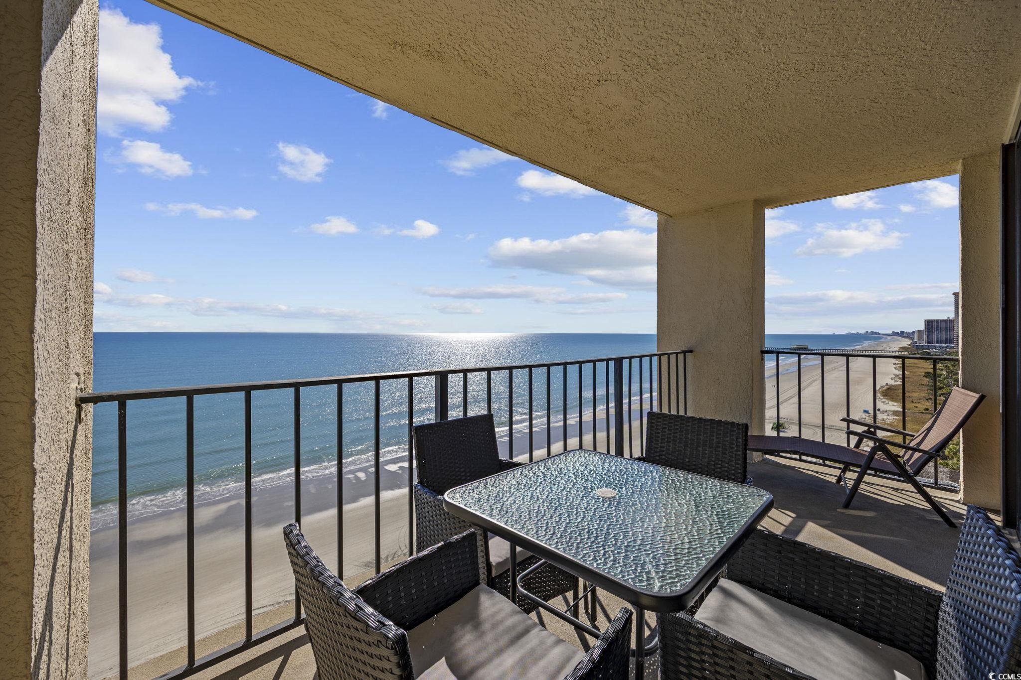 10100 Beach Club Drive, Unit 14F Myrtle Beach, SC 29572 - Photo 10 of 40 Balcony with view of water and beach and outdoor dining space