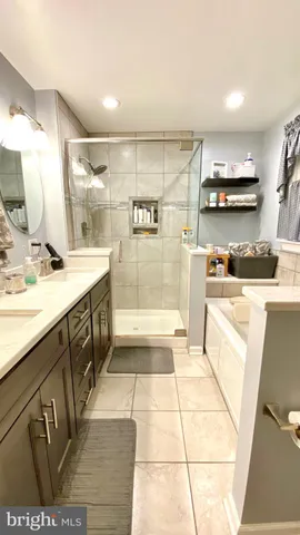 a bathroom with a sink a mirror and a shower