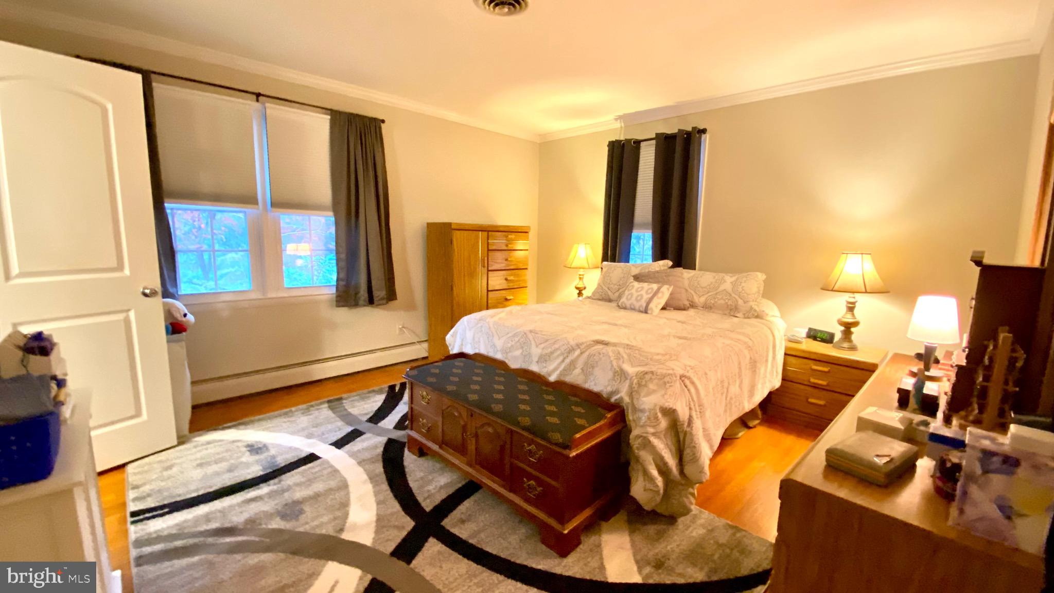 13904 Blenheim Road North Phoenix, MD 21131 - Photo 15 of 37 a bedroom with a bed and wooden floor