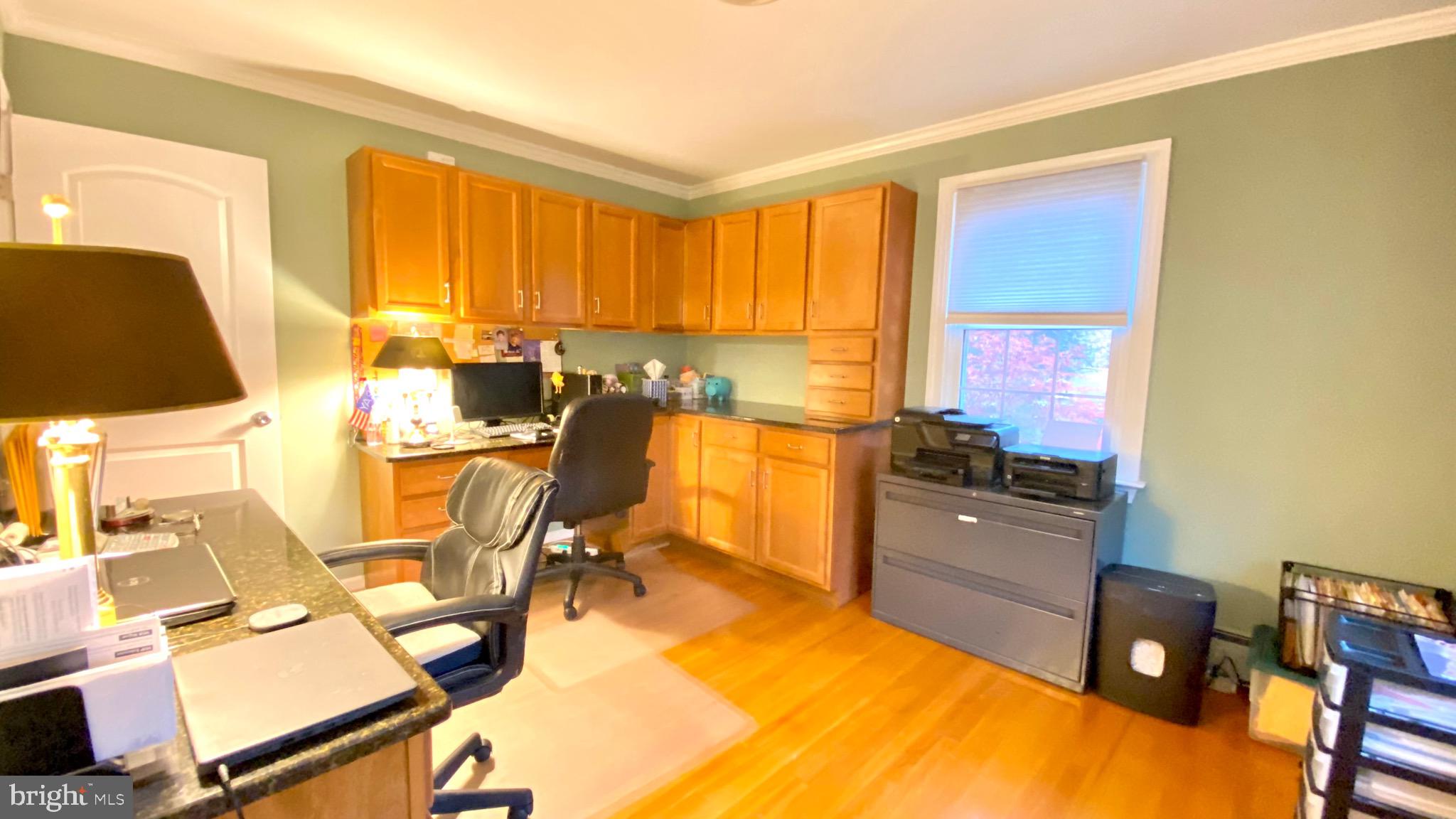 13904 Blenheim Road North Phoenix, MD 21131 - Photo 17 of 37 a view of a workspace with furniture and a window