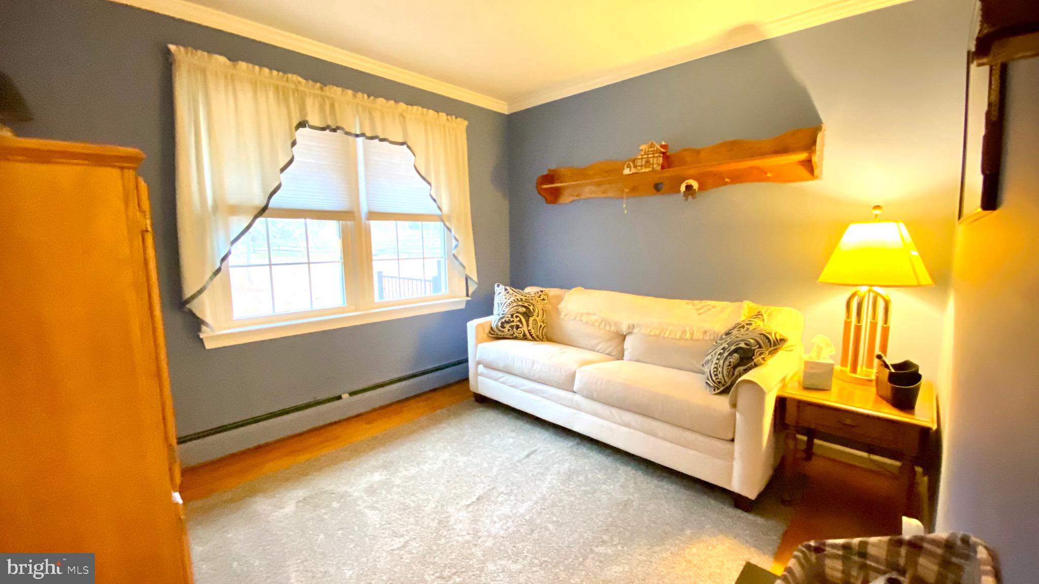13904 Blenheim Road North Phoenix, MD 21131 - Photo 18 of 37 a living room with furniture and a large window