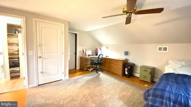 a view of a workspace with furniture and a window