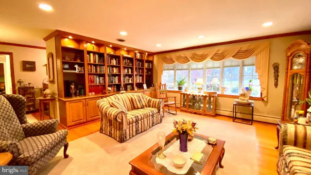 a living room with furniture a rug and a large window
