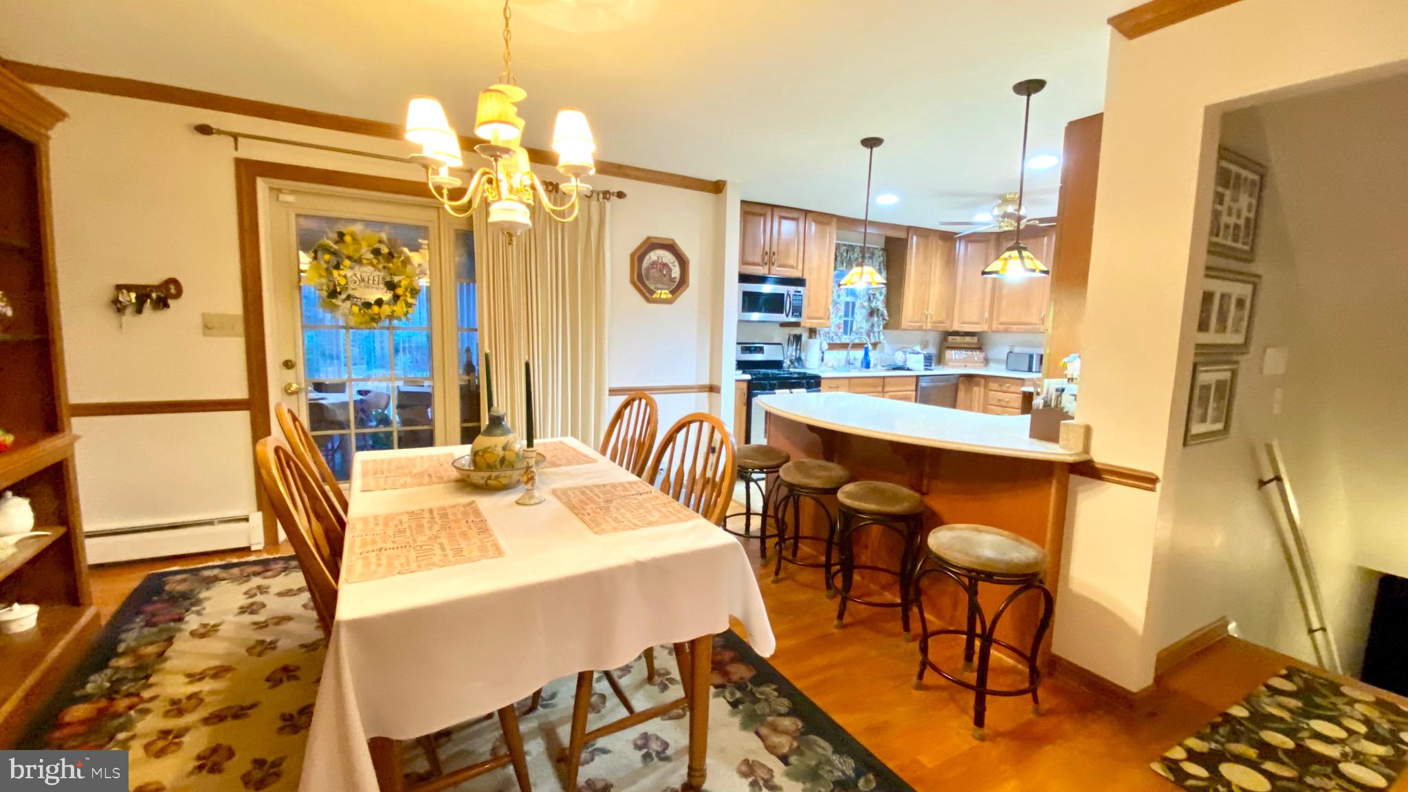 13904 Blenheim Road North Phoenix, MD 21131 - Photo 10 of 37 a view of a dining room with furniture and a chandelier