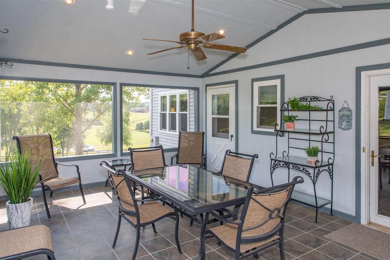 14 Thacker Mill Road Verona, VA 24482 - Photo 36 of 47 a dining room with furniture a chandelier and wooden floor