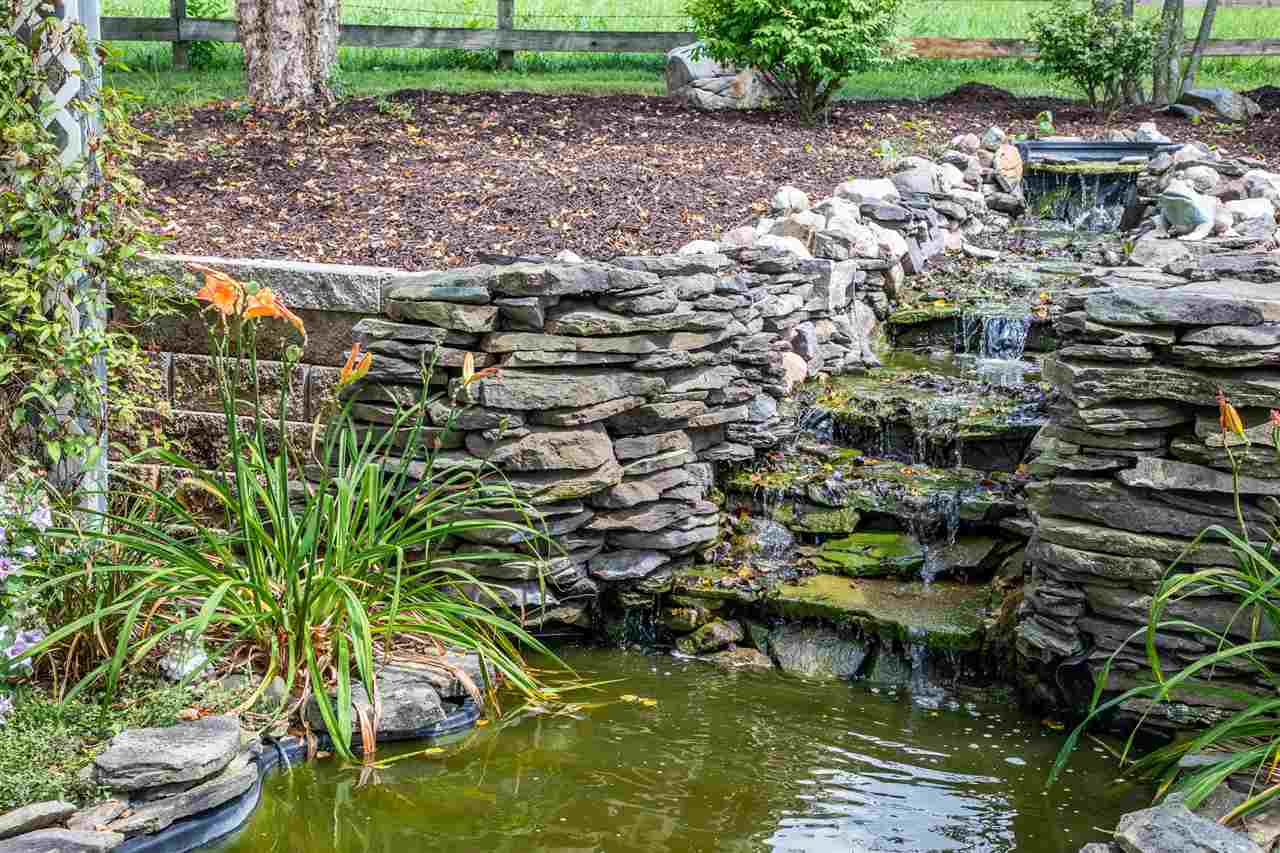 14 Thacker Mill Road Verona, VA 24482 - Photo 6 of 47 a view of a lake with a garden