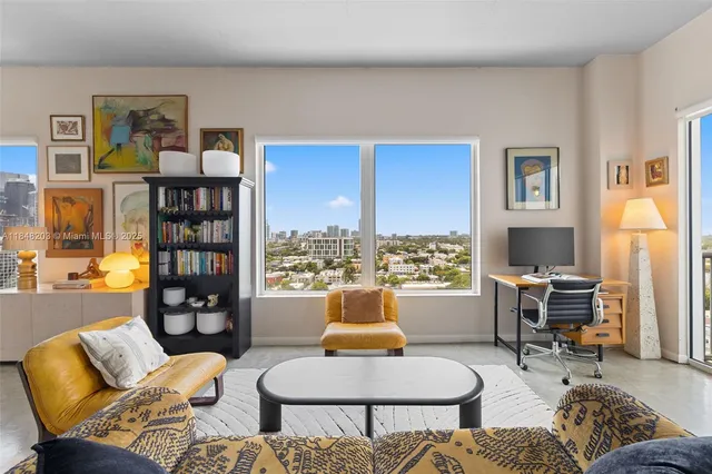 a living room with furniture and a large window