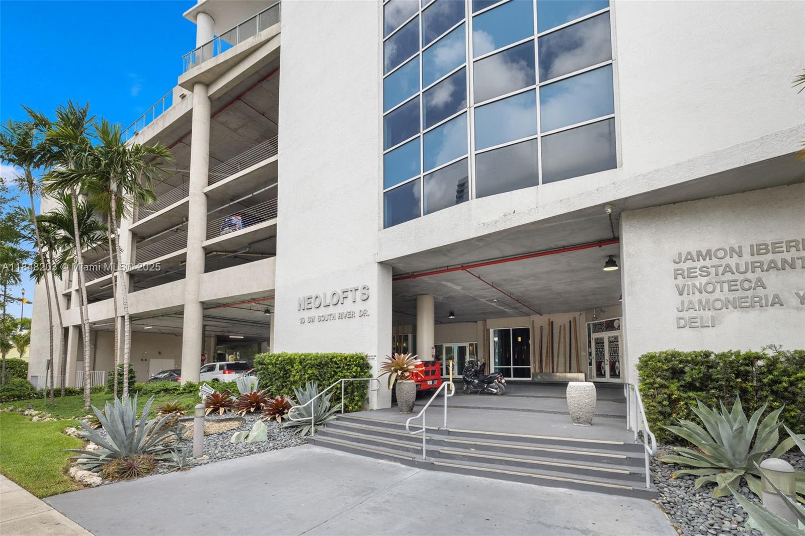 10 Southwest South River Drive, Unit 1614 Miami, FL 33130 - Photo 21 of 21 a view of a building with potted plants and a large tree