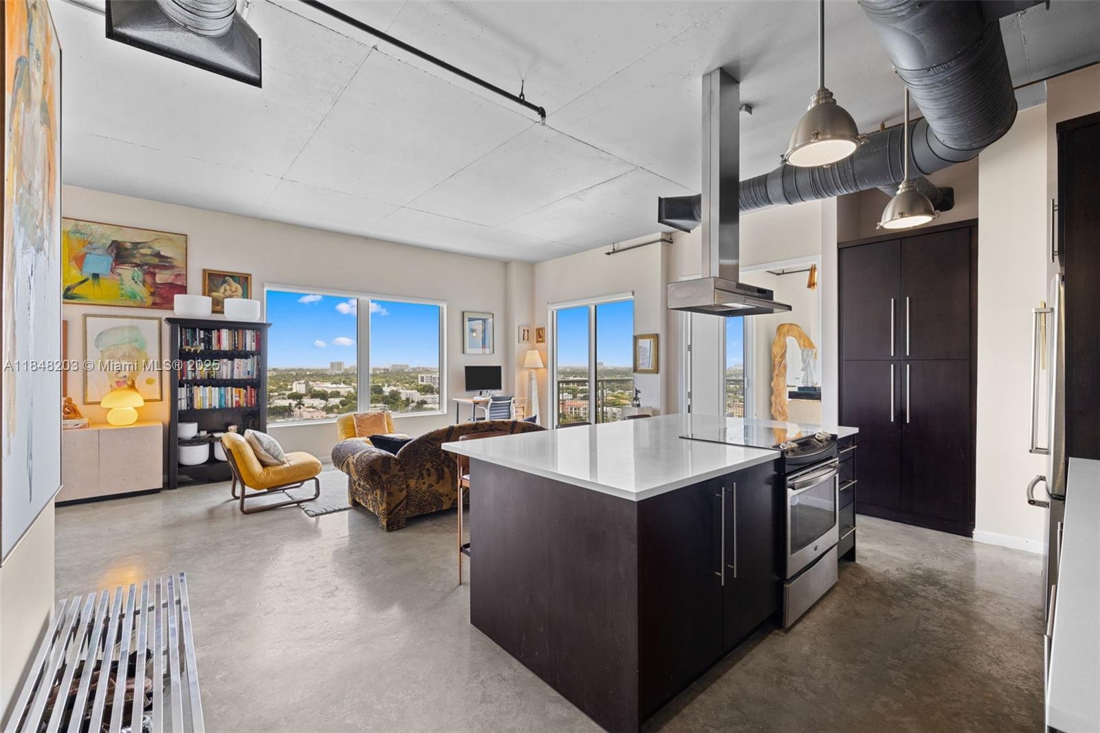 10 Southwest South River Drive, Unit 1614 Miami, FL 33130 - Photo 6 of 21 a kitchen with counter top space and living room view