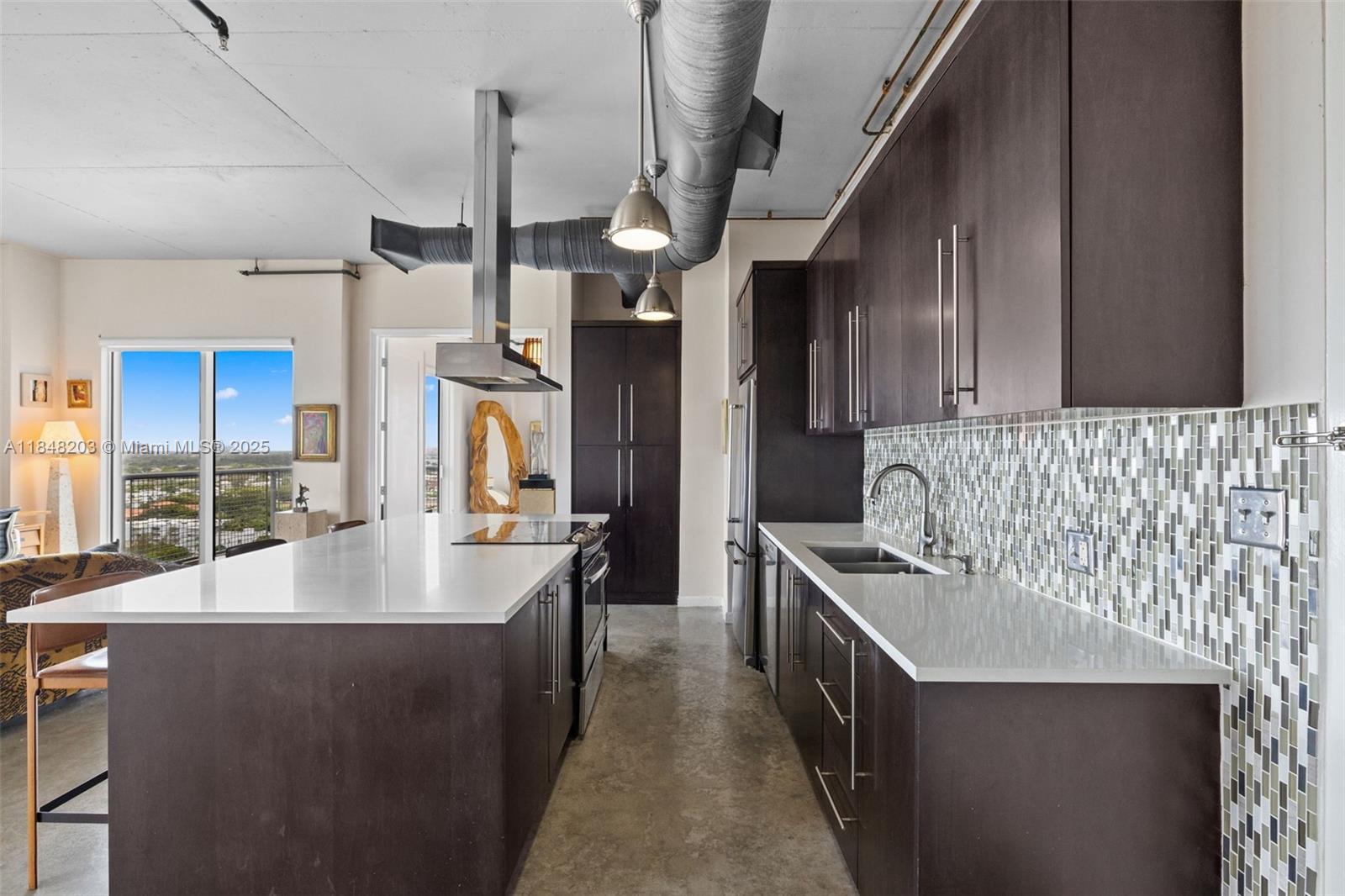10 Southwest South River Drive, Unit 1614 Miami, FL 33130 - Photo 7 of 21 a kitchen with stainless steel appliances granite countertop a sink a stove and a refrigerator