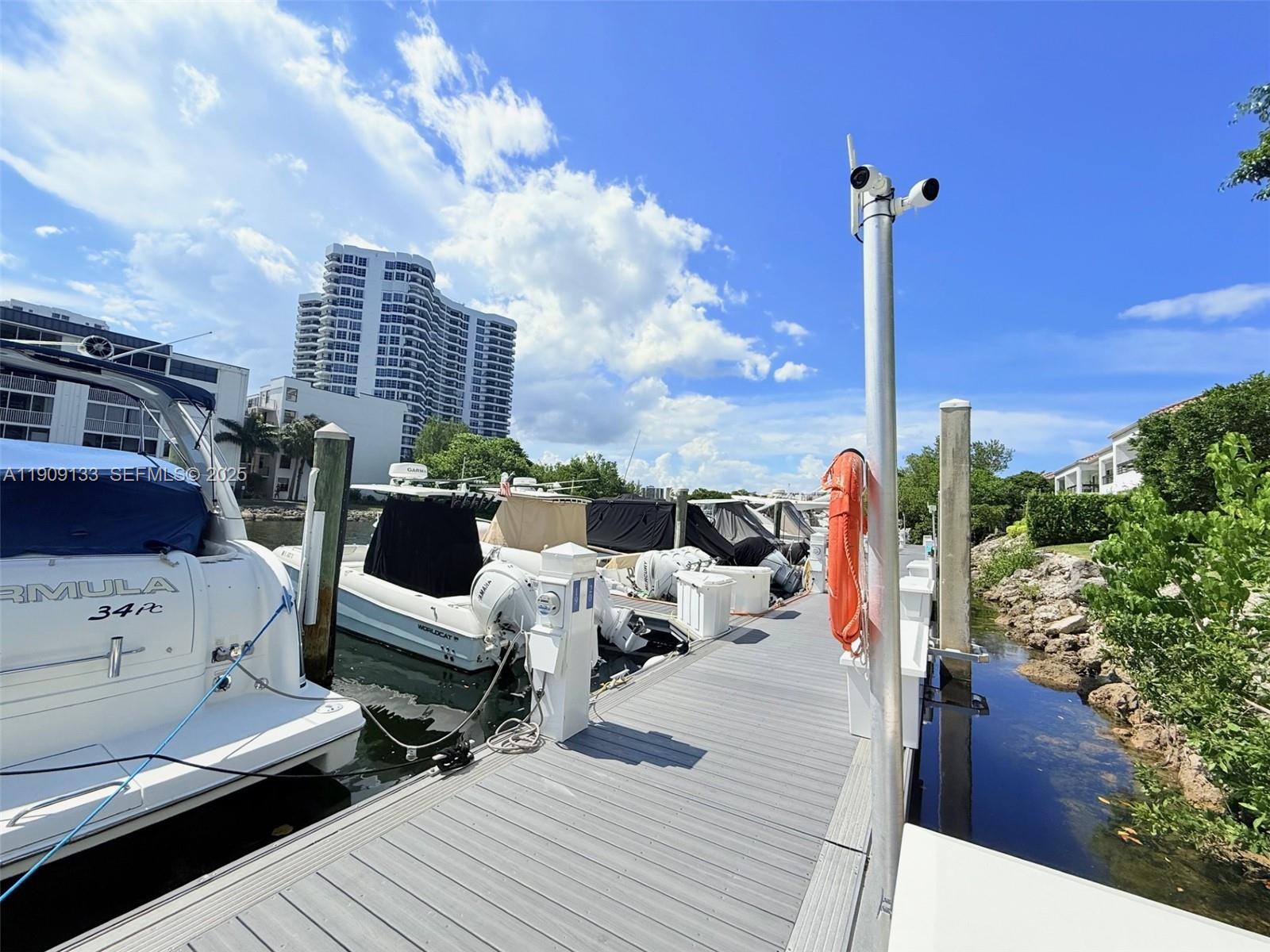3530 Mystic Pointe Drive, Unit 1204 Aventura, FL 33180 - Photo 6 of 16 a roof deck view with couches and wooden floor