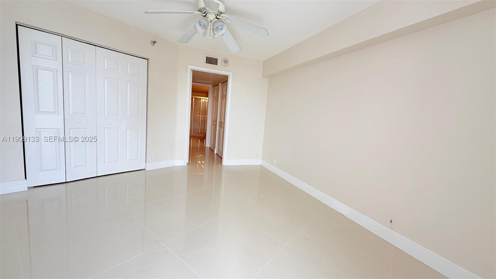 3530 Mystic Pointe Drive, Unit 1204 Aventura, FL 33180 - Photo 7 of 16 a view of an empty room with a window