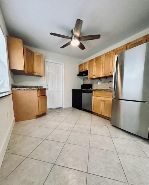 1800 Northeast 4th Street Pompano Beach, FL 33060 - Photo 2 of 8 a kitchen with stainless steel appliances granite countertop a refrigerator a stove top oven and a sink