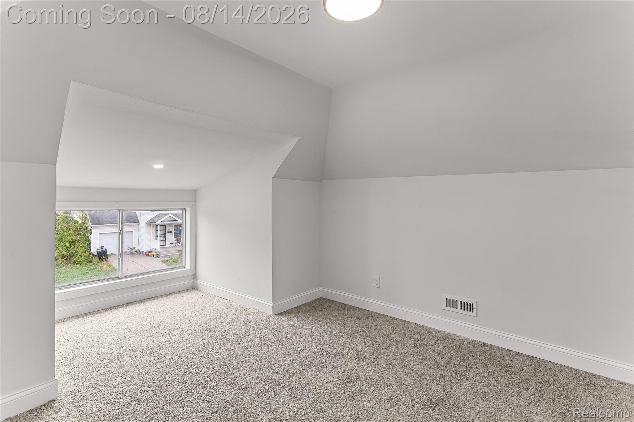4472 French Road Detroit, MI 48214 - Photo 13 of 23 Vaulted ceiling with recessed lighting, wall-to-wall carpeting, and a large window