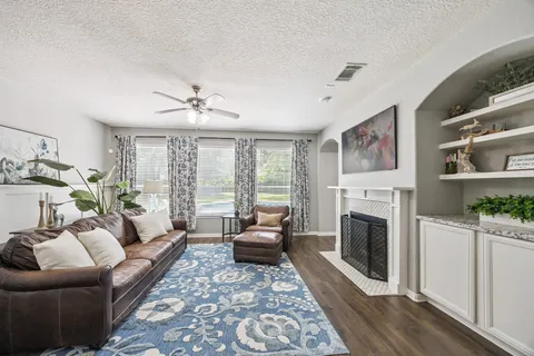 a living room with furniture a window and a fireplace