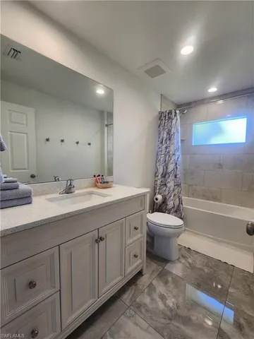 a bathroom with a double vanity sink toilet and shower