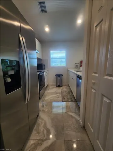 a room with a refrigerator and washer
