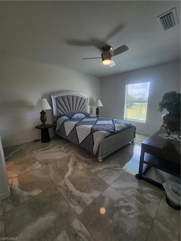 a spacious bedroom with a bed and a couch