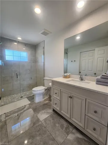 a spacious bathroom with a double vanity sink toilet and a shower