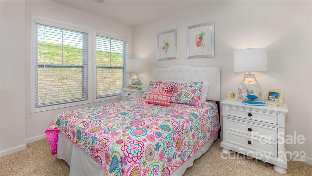131 Creekview Road Hendersonville, NC 28792 - Photo 16 of 30 a bedroom with a bed and a window