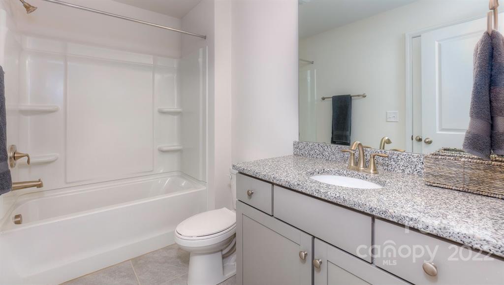 131 Creekview Road Hendersonville, NC 28792 - Photo 18 of 30 a bathroom with a granite countertop sink toilet and shower