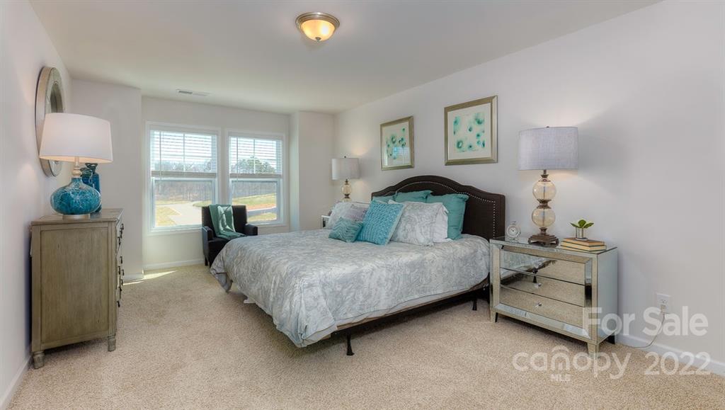 131 Creekview Road Hendersonville, NC 28792 - Photo 23 of 30 a bedroom with a bed a table and window
