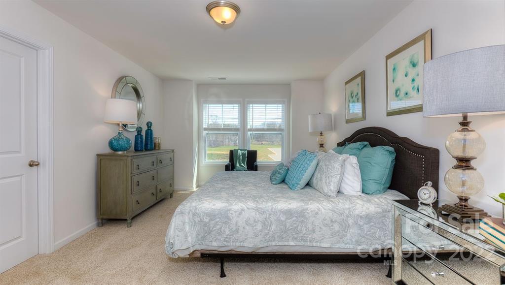 131 Creekview Road Hendersonville, NC 28792 - Photo 24 of 30 a bedroom with a bed and a window