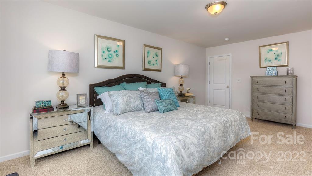 131 Creekview Road Hendersonville, NC 28792 - Photo 25 of 30 a bedroom with a bed and a lamp on dresser