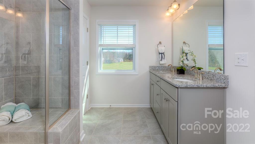 131 Creekview Road Hendersonville, NC 28792 - Photo 26 of 30 a bathroom with a granite countertop sink and a mirror