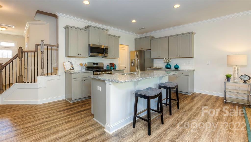 131 Creekview Road Hendersonville, NC 28792 - Photo 5 of 30 a kitchen with a sink cabinets and wooden floor