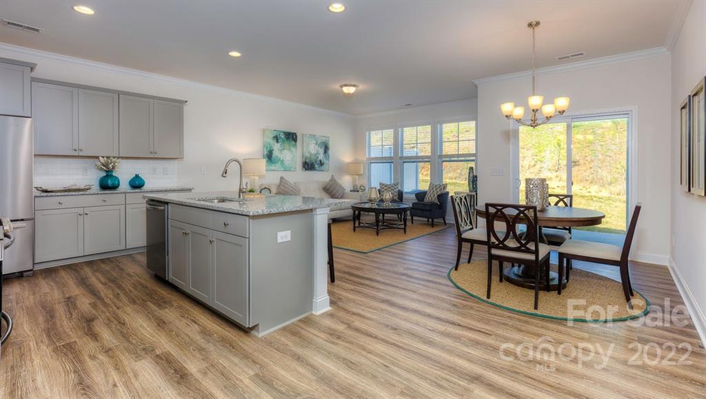 131 Creekview Road Hendersonville, NC 28792 - Photo 10 of 30 a living room with granite countertop kitchen island furniture and a chandelier